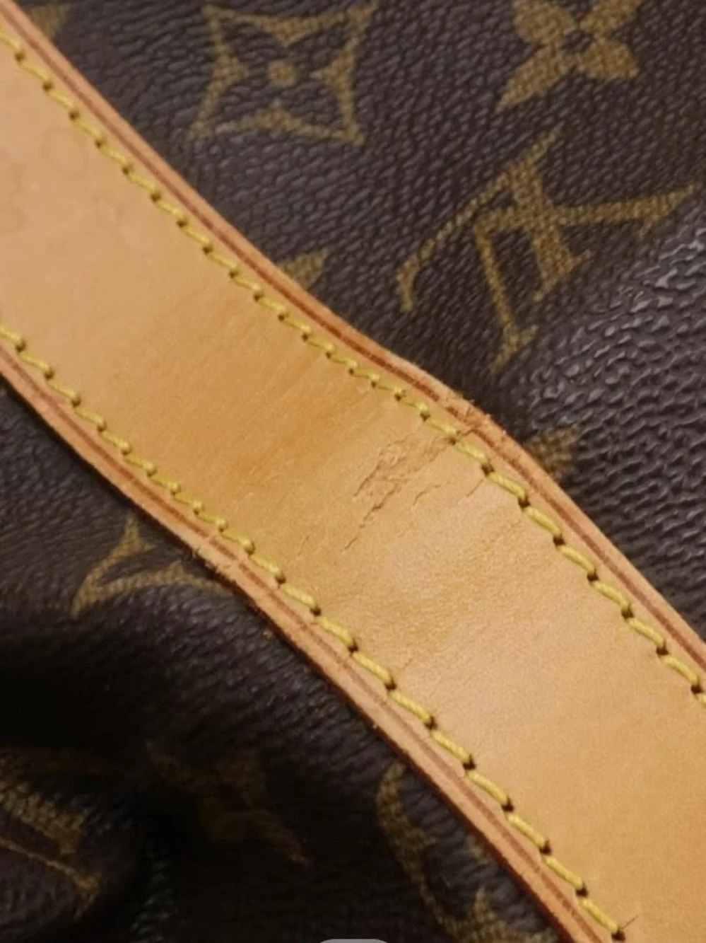 The Louis Vuitton Keepall Bandoulière 50 features iconic Monogram Canvas and Vac